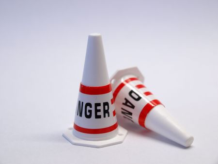 Two cones on white background with danger noticeの写真素材
