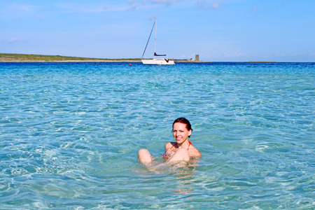 Happy girl relaxing in the crystal clear sea, La Pelosa, Sardinia, Italy の写真素材