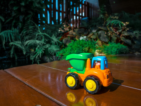 Small decorative toy track at the garden home. Macro abstract photo. Construction, mining, construction equipment at work holiday for babyの写真素材