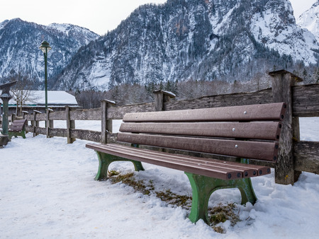 Wooden Chair outdoor in national park and moutain background winter season snowの写真素材