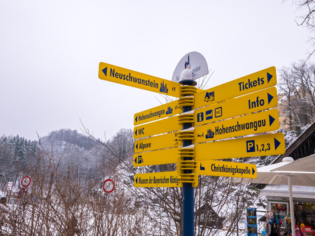 Schwangau, Germany - FEBUARY 23, 2018: Tourist information sign at famous Neuschwanstein Castle in the Bavarian Alps of Germany.のeditorial素材