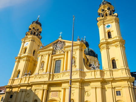 feldherrnhalle and tower of theatinerkirche theatinerchurch at odeon square odeonplatz in munich city bavaria germany tower clock time detail landscape orientation.Winter season Germany.の写真素材