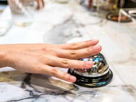 call bell in restaurant vintage with hand service granite background luxury.の写真素材