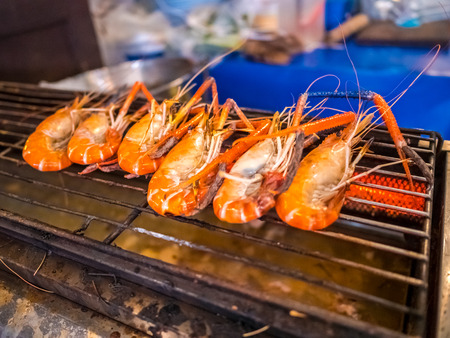 Grilled giant river prawn or big shrimp on stove with selective focus.A recommended menu for tourists when they come to Thailand. The prawn is served with spicy seafood sauce.の写真素材