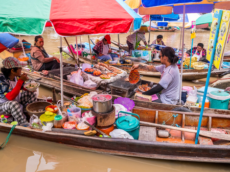 THAILAND, SAMUTSONGKHRAM - JUNE 17,2018:People shopping and eating at Amphawa floating market in Thailand.The destination for tourist is a famous place to traditional cuture Thailand.のeditorial素材