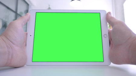 Man Watching Tablet with Chroma Screenの写真素材