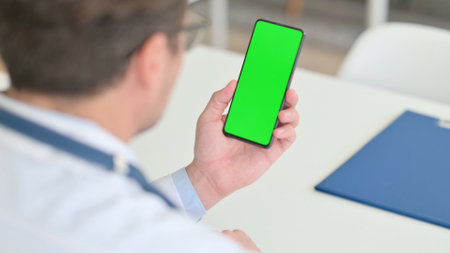 Doctor Holding Smartphone with Green Chroma Key Screenの写真素材