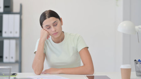 Tired Sleeping Young Latin Woman in Officeの写真素材