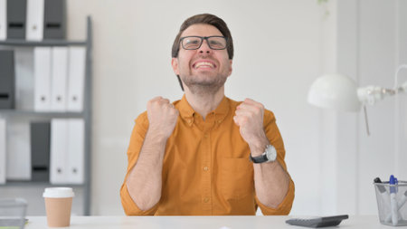 Young Man Celebrating Success of Projectの写真素材