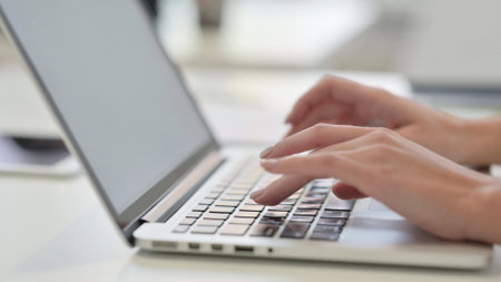 Female Hands Typing on Laptop, Side Viewの写真素材