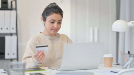 Young Indian Woman Paying Online by Using Credit Cardの写真素材