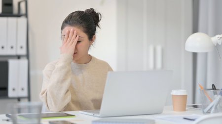 Young Indian Woman with Laptop Reacting to Lossの写真素材