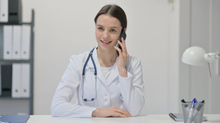 Female Doctor Talking on Smartphoneの写真素材