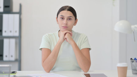 Brainstorming Young Latin Woman Thinking at Workの写真素材