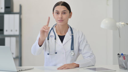 Denying Female Doctor Waving Finger as Noの写真素材