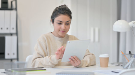 Young Indian Woman using Tablet, Browsing Internetの写真素材