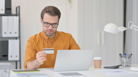 Online Payment Success on Laptop by Young Manの写真素材