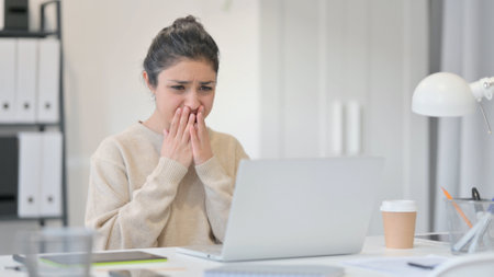 Tense Young Indian Woman in Shock at Workの写真素材