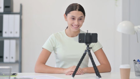 Young Latin Woman Blogging on Smartphone, Video Chatの写真素材