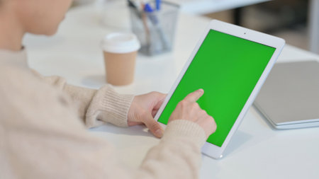 Woman using Tablet with Chroma Screenの写真素材