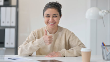 Thumbs Up Sign by Young Indian Womanの写真素材