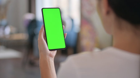 Latin Woman Holding Smartphone with Green Chroma Screen