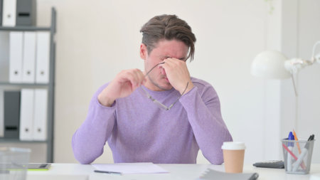 Middle Aged Man having Headache in Officeの写真素材