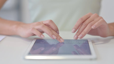 Close Up of Female Hands Typing on Tablet