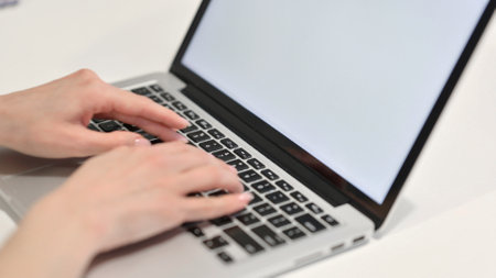 Hands of Young Woman Typing on Laptopの写真素材
