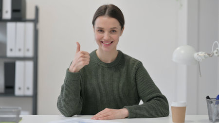 Thumbs Up Sign by Young Womanの写真素材