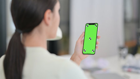 Woman Holding Smartphone with Chroma Screen, Mock Upの写真素材