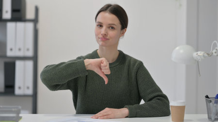 Thumbs Down by Young Womanの写真素材