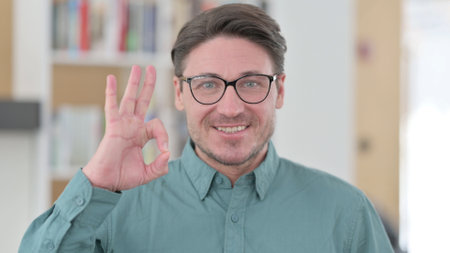 Middle Aged Man showing Ok Sign by Handの写真素材