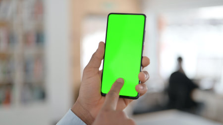 African Man using Smartphone with Green Chroma Key Screenの写真素材