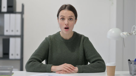 Shocked Young Woman Wondering with Open Mouthの写真素材