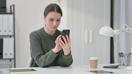 Young Woman using Smartphone, Browsing internetの写真素材