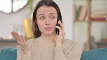 Portrait of Young Woman Talking on Smartphoneの写真素材