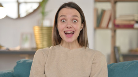 Portrait of Excited Young Woman Celebrating at Home