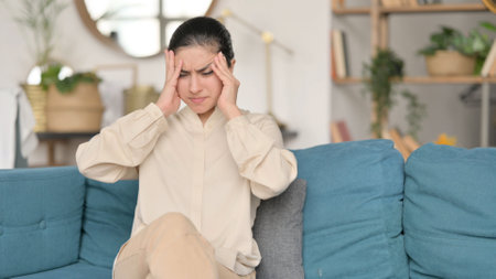 Young Indian Woman with Headache on Sofaの写真素材