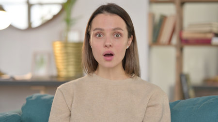 Portrait of Shocked Young Woman Wondering in Aweの写真素材