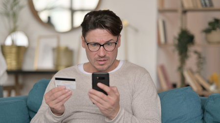 Portrait of Online Shopping Failure on Smartphone by Middle Aged Manの写真素材