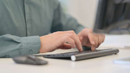 Man Typing on Keyboard at Work
