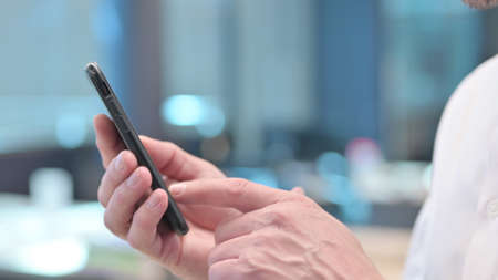 Close up of Middle Aged Arab Man using Smartphoneの写真素材