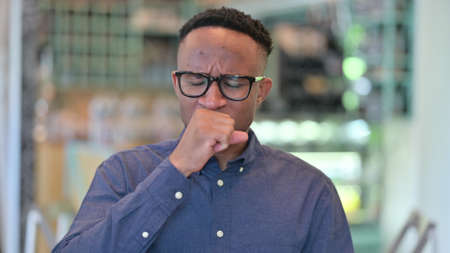 Portrait of Sick Young African Man Coughingの写真素材