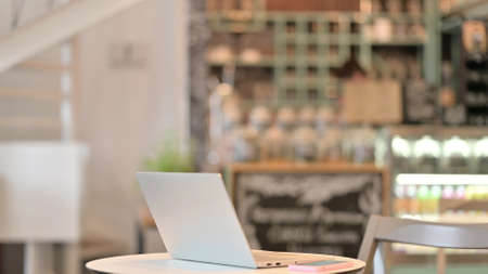 Open Laptop on Table in Cafeの写真素材