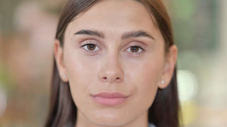 Close up of Serious Young Woman Looking at Cameraの写真素材