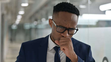 Portrait of Sick Young African Businessman Coughing