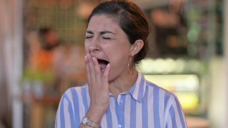 Portrait of Sleepy Young Indian Woman Yawning