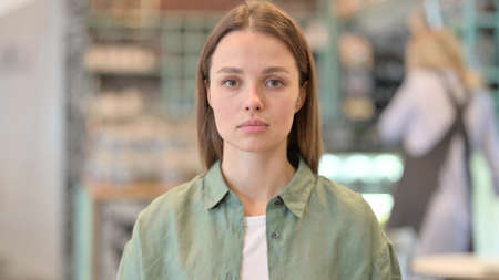 Portrait of Serious Woman Looking at Cameraの写真素材