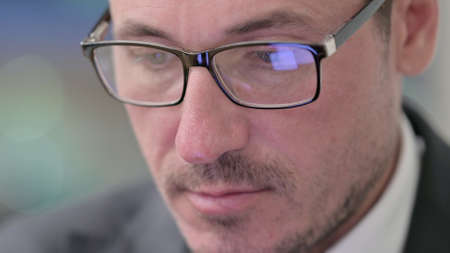 Face of Middle Aged Man using Smartphone